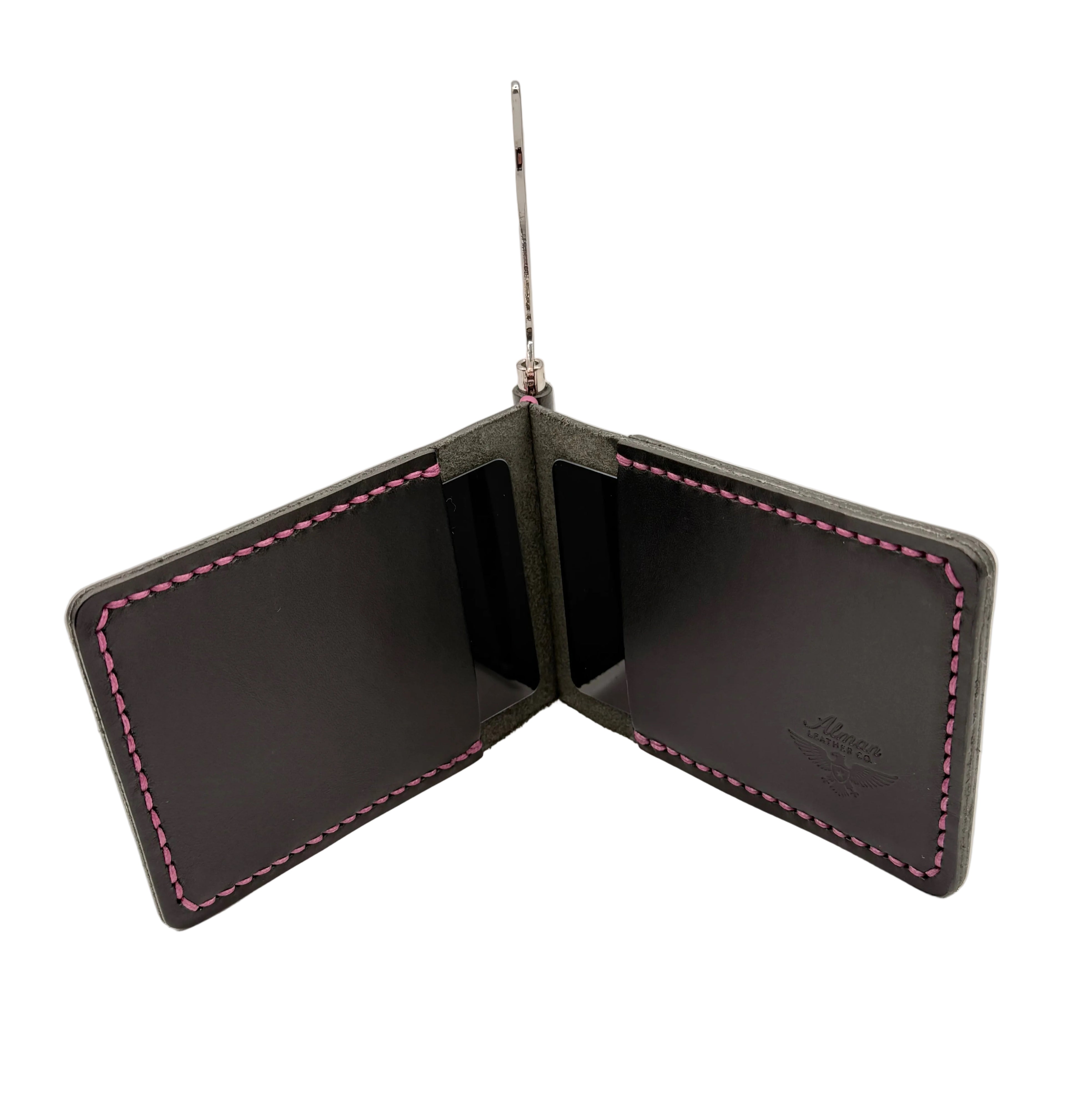 Black leather wallet with urple stitching on a light gray background