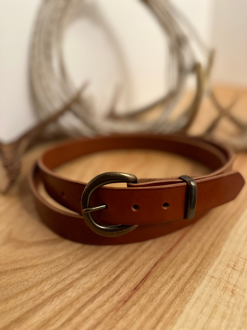Brown leather belt with a brass buckle