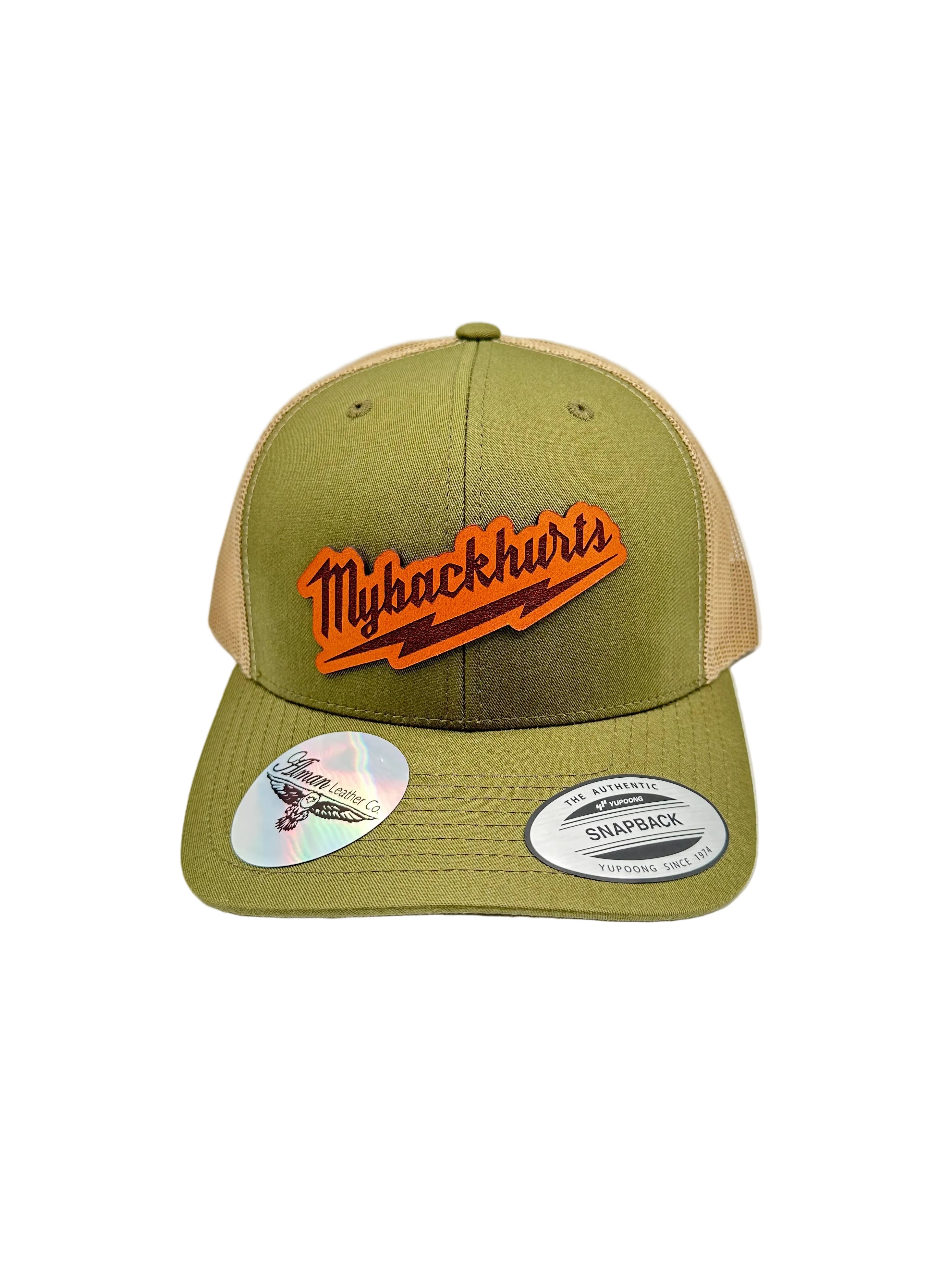 Green and beige cap with leather patch  on a white background